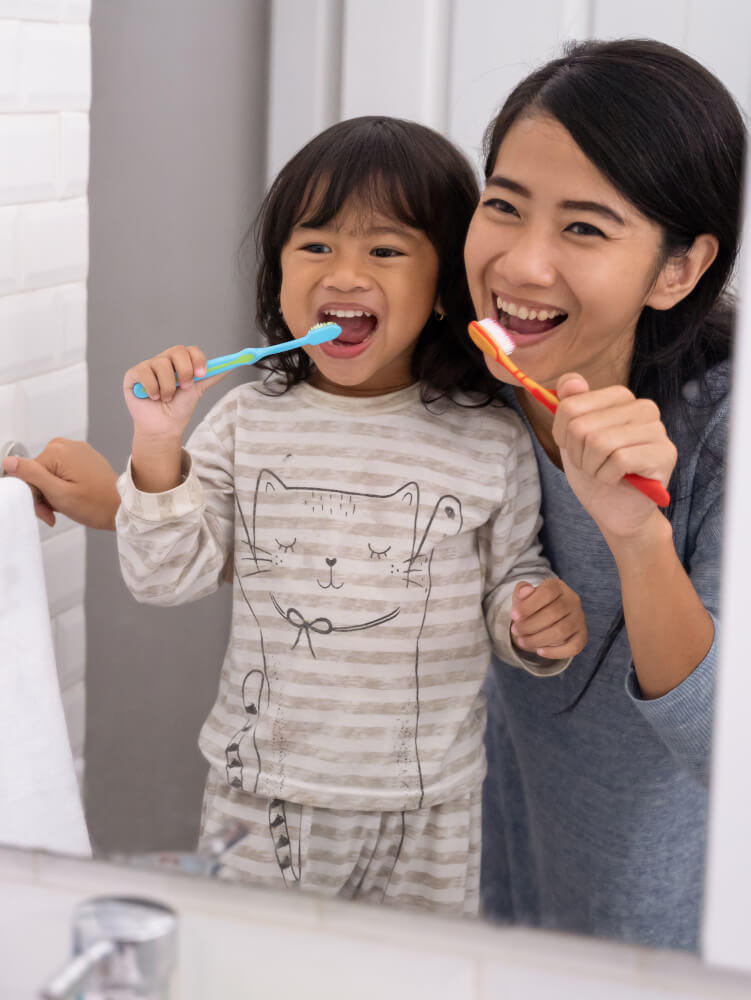 Mom and Daughter Brushing Teeth