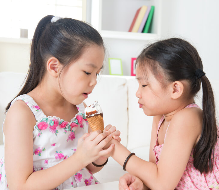girls sharing ice cream