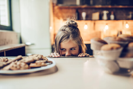 girl looking at cookies